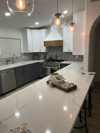 a kitchen with white counter tops