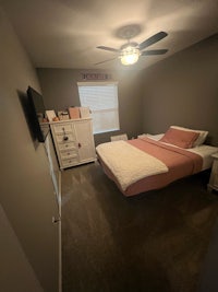 a bedroom with a bed and a ceiling fan