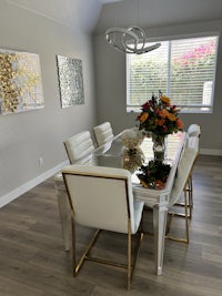 a dining room with a white table and chairs